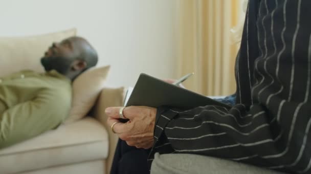 Colpo Arco Ritagliato Terapeuta Donna Annotando Nel Taccuino Durante Ascolto — Video Stock