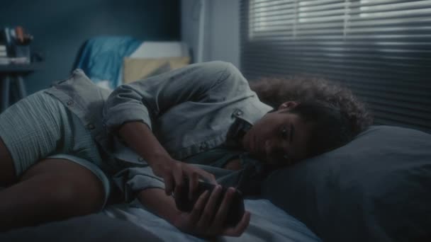 Upset African American Teen Girl Lying Bed Dark Room Doomscrolling — Stock Video