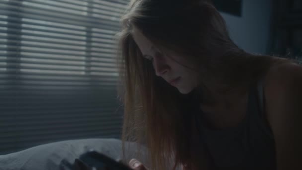 Tilt Shot Nervous Girl Sitting Dark Bedroom Doomscrolling Phone Feeling — Stock Video