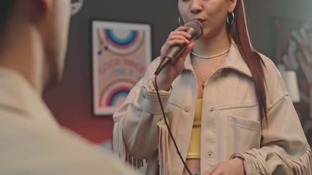 Shoulder Shot Young Cheerful Woman Holding Mic Looking Boyfriend Singing — Stock Video
