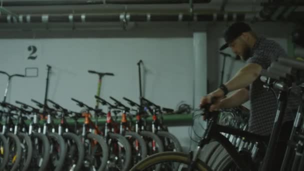 Medium Long Shot Male Worker Walking Bicycle Garage Royalty Free Stock Footage