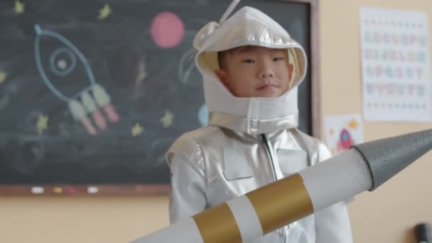 Zoom Portrait Little Asian Boy Dressed Astronaut Suit Holding Handmade — Stock Video