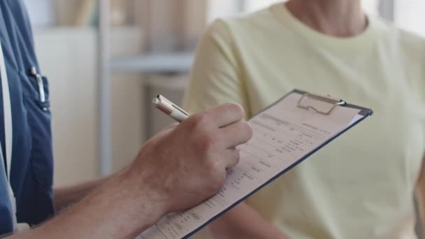Close Shot Hands Male Doctor Filling Out Patients Form Clipboard — Stock Video