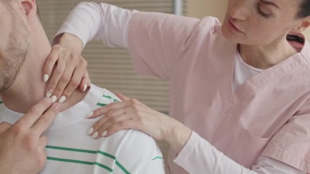 Przycięte Ujęcie Kobiecego Terapeuty Dotykającego Mięśnie Ramion Szyi Mężczyzny Podczas — Wideo stockowe