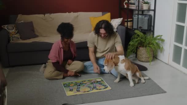 Young Modern Ethnically Diverse Couple Dog Sitting Floor Cozy Living — Stock Video