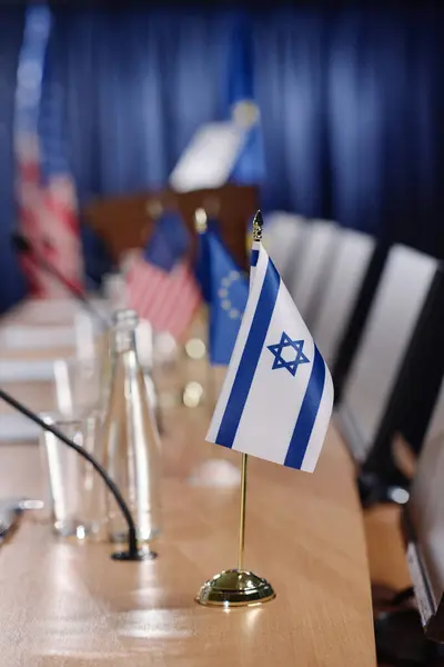 Vertical image of table with Israel flag and microphone preparing for military conference