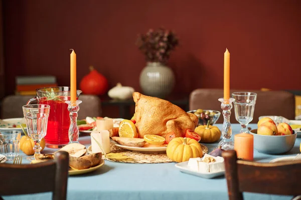 Medium full shot of roasted turkey displayed on thanksgiving festive table among other treats