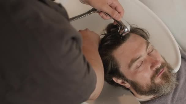 Top Shot Bearded Man Leaning Back Sink While Barber Rinsing — Stok Video
