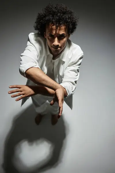 stock image Young man moving his hands posing in white studio background