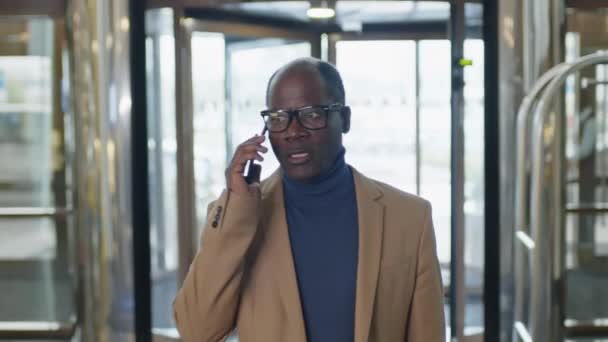 아프리카계 미국인 사업가의 호텔의 리셉션 영역을 전화로 말하기 — 비디오