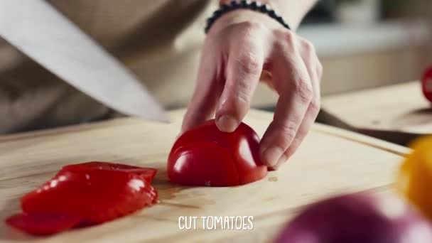 木製カッティングボードにナイフ付きの熟したトマトをスライスしたシェフの手 下の画面に表示される字幕 ソーシャルメディアチャンネルやブログを調理するためのビデオレシピ — ストック動画
