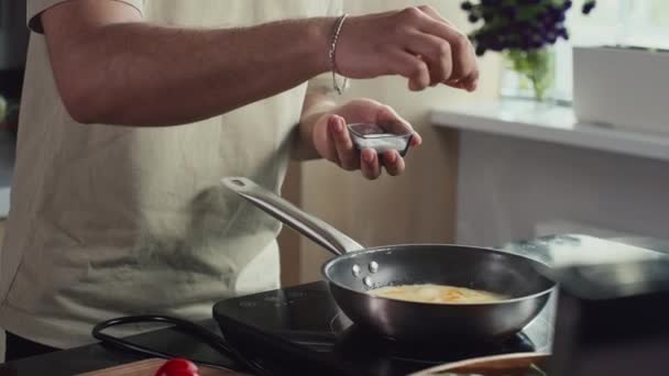 Beskuren Bild Oigenkännlig Man Som Tillsätter Salt Till Omelett Som — Stockvideo