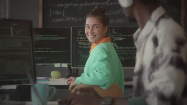 Young Caucasian Female Programmer Coding Computer Chatting African American Colleague — Stock Video
