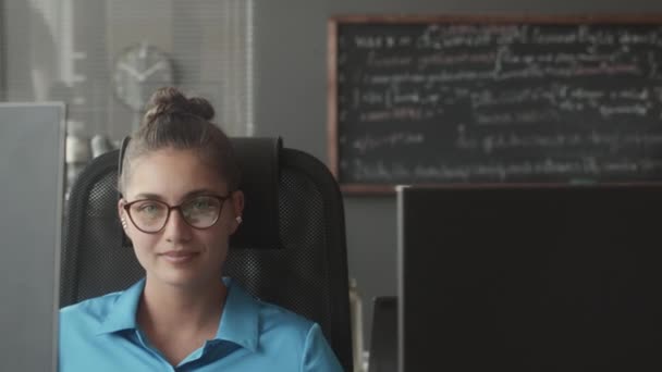 Portrait Young Female Specialist Eyeglasses Posing Camera Desk Computer Dual — Stock Video