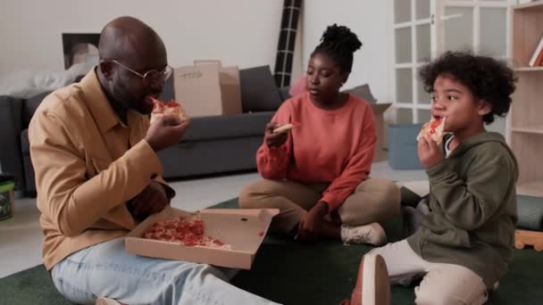 Familia Afroamericana Sentada Piso Apartamento Nuevo Después Mudarse Descansar Comer — Vídeo de stock