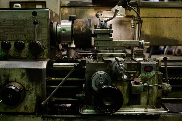 No people shot of part of old lathe machine in industrial workshop interior, copy space