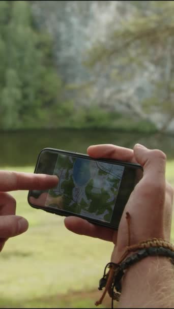 Vertical Close Shot Hands Hiker Looking Map Smartphone Pointing Direction — Stock Video