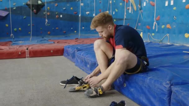 Fiatal Férfi Sportruházatban Szőnyegen Mászó Tornateremben Felveszi Cipőt Edzés Előtt — Stock videók