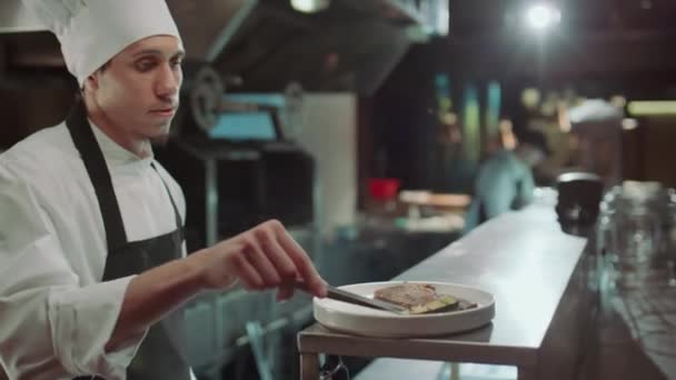 Šéfkuchař Zástěře Klobouku Pomocí Pinzety Při Přidávání Grilované Zeleniny Jako — Stock video