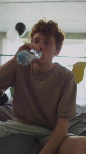Függőleges Lövés Fiatal Férfi Ágyon Otthon Ivóvíz Üvegből Miközben Szomjas — Stock videók