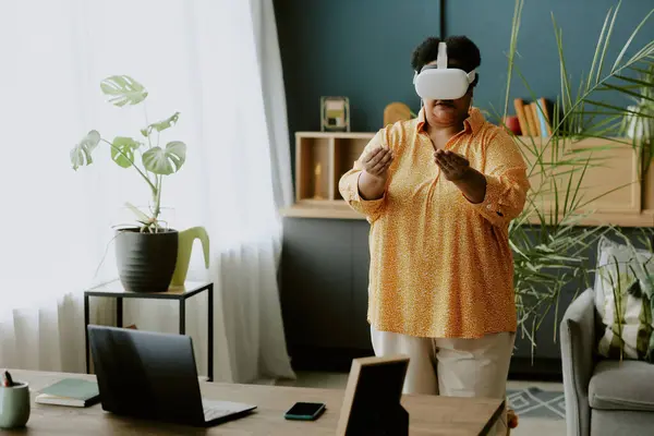 stock image Retired African American woman experiencing new technologies with help of VR headset