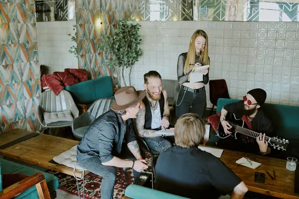 stock image High angle shot of group of male and female rock musicians spending time together in their studio in abandoned house working on new album