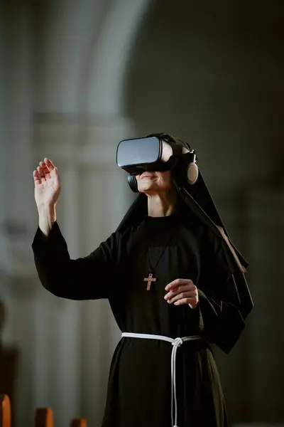 stock image Vertical shot of modern mature Caucasian Catholic nun standing inside abbey building using VR headset, copy space