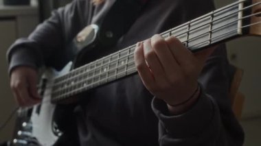 Sınıfta müzik dersi sırasında elektro gitarla şarkı çalan tanınmayan çocuğun ellerine yakından bakın.
