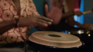 Barda caz konseri sırasında konga çalan Afrikalı Amerikalı müzisyen, arka planda davulcu