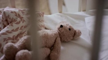 Kimse rahat, boş bir bebek karyolasında uzanan, rahat yatak odasında duran sevimli kahverengi oyuncak ayıcığını yakından çekmez.