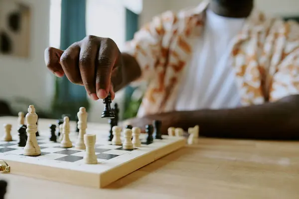 stock image Closeup of hand of unrecognizable African American male chess player moving pawn piece, copy space