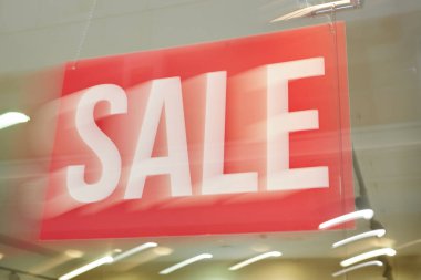 Modern alışveriş merkezinin tavanına asılı kocaman kırmızı pankart.