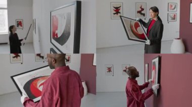 Asya ve Afrika kökenli Amerikalı sanat küratörlerinin duvarlara resim ve asma sanatları denetlemesi, galeride soyut sanat sergisi için hazırlanmaları.