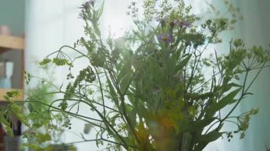 Mutfakta güneş ışığıyla dolu bir buket taze kır çiçeği yakın plan.