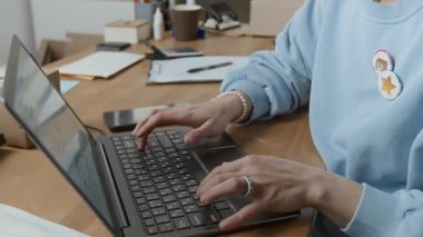 Genç bayan depo yöneticisinin laptopta veri işleme görüntüsünü kaldır ve iş günü gelen aramalara cevap ver