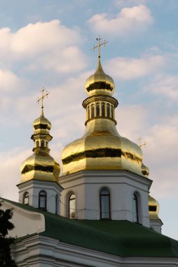 Kyiv Pechersk Lavra 'nın altın kubbeleri akşam gökyüzünün arka planına karşı