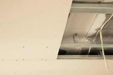 Şantiyede inşaat işçileri tarafından alçıpan montaj çalışmaları devam ediyor.