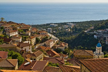 The picturesque greek style village of Dhermi at the coastal road of Albania photographed from the hill behind the village. You have to go through the hotel there to reach this place. clipart