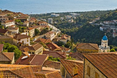 The picturesque greek style village of Dhermi at the coastal road of Albania photographed from the hill behind the village. You have to go through the hotel there to reach this place. clipart