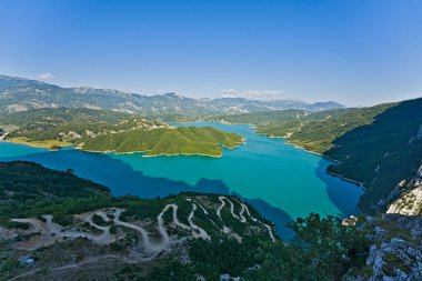 Bovilla reservoir near the capital of Tirana with setting sun in the back. clipart