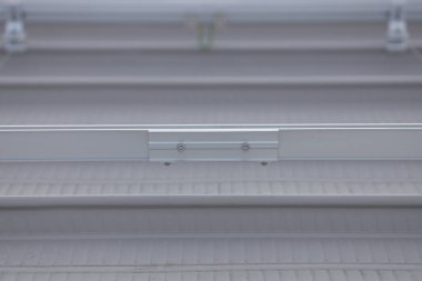 The connection point of two rail sections. Rail splice tighten with nuts connecting two rail sections. Rail for supporting solar panels. clipart