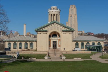 Pittsburgh, Pennsylvania, USA: March 24, 2024: Hamerschlag Hall on the campus of Carnegie Mellon University and the Cathedral of Learning on the University of Pittsburgh campus on a sunny spring day clipart