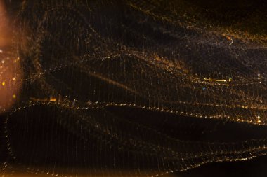 Light Bokeh. Bokeh, yanıp sönen sarı ışıklar kahverengi üzerine. Sarı-kahverengi tonlarda soyut bulanık arkaplan. Işık hareketi efekti.