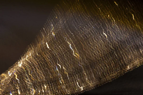 Light Bokeh. Bokeh, yanıp sönen sarı ışıklar kahverengi üzerine. Sarı-kahverengi tonlarda soyut bulanık arkaplan. Işık hareketi efekti.