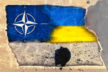 NATO Kuzey Atlantik Antlaşması Örgütü bayrağı ve Ukrayna bayrağı, yırtık desenli, lekeli kağıtlardan oluşan soyut bir arkaplanda.