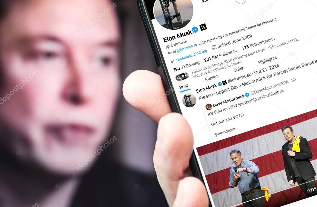 Ukraine. Poltava. October 21, 2024. Elon Musk profile on a smartphone screen. New tweet with text. In the background is a defocused portrait of Elon Musk.