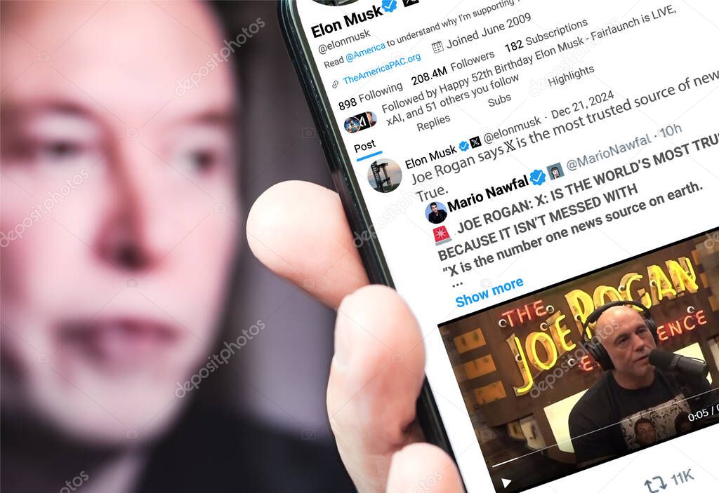 Poltava, Ukraine - 21, December 2024. Elon Musk Twitter profile page with a new tweet on a smartphone in his hand. In the background is a defocused portrait of Elon Musk.