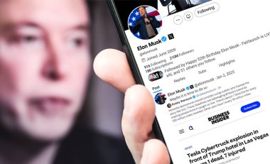 Poltava, Ukrayna - 2 Ocak 2025. Elon Musk Twitter profili sayfasında elinde akıllı telefonuyla yeni bir tweet var. Arka planda Elon Musk 'un odaksız bir portresi var..