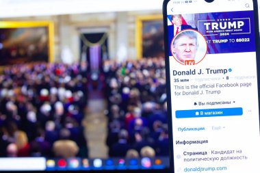 20 Ocak 2025. Ukrayna. Polta. 2025 'in açılış törenini laptop ekranında, ön planda Trump Facebook profilini akıllı telefon ekranında. Yumuşak odak.