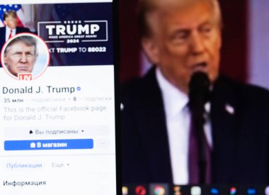 20 Ocak 2025. Ukrayna. Polta. 2025 'in açılış törenini laptop ekranında, ön planda Trump Facebook profilini akıllı telefon ekranında. Yumuşak odak.